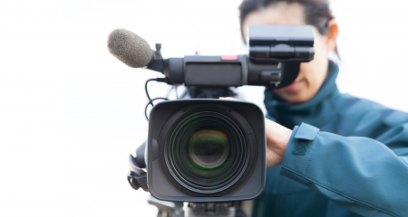 videographer pointing camera at screen