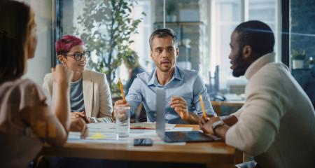 Small group of workers sitting at a table talking