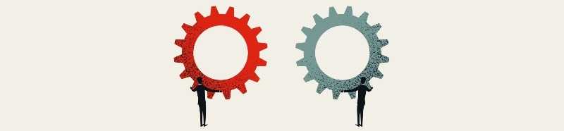 two people holding two different cogs