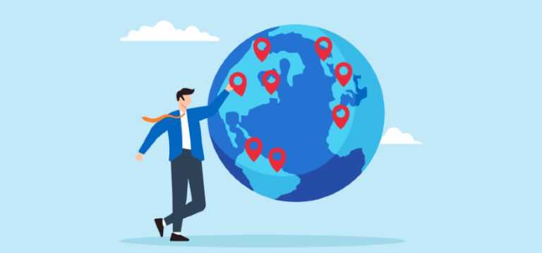 a man next to a globe covered in pins