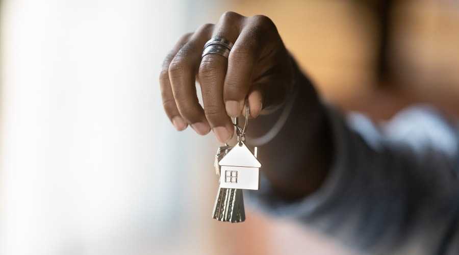 a hand holding a set of house keys
