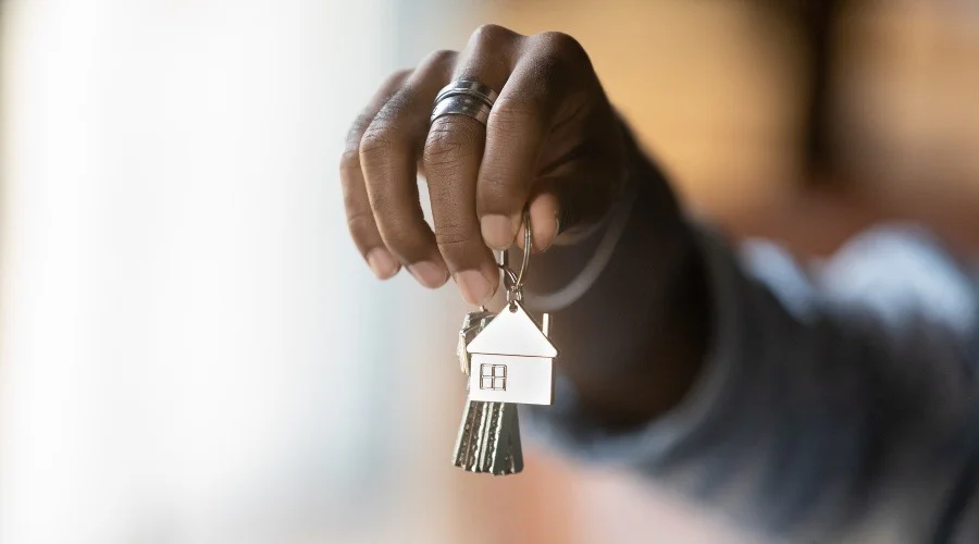 a hand holding a set of house keys