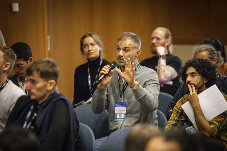 an attendee asking a question into a microphone