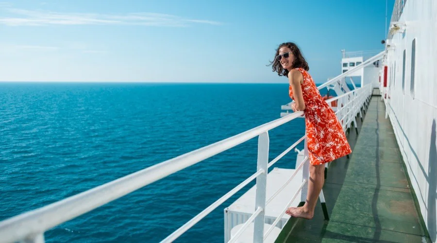 a woman on the deck of a cruise ship