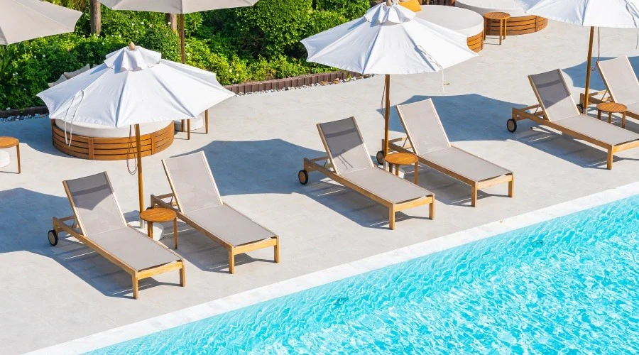 deck chairs by a swimming pool