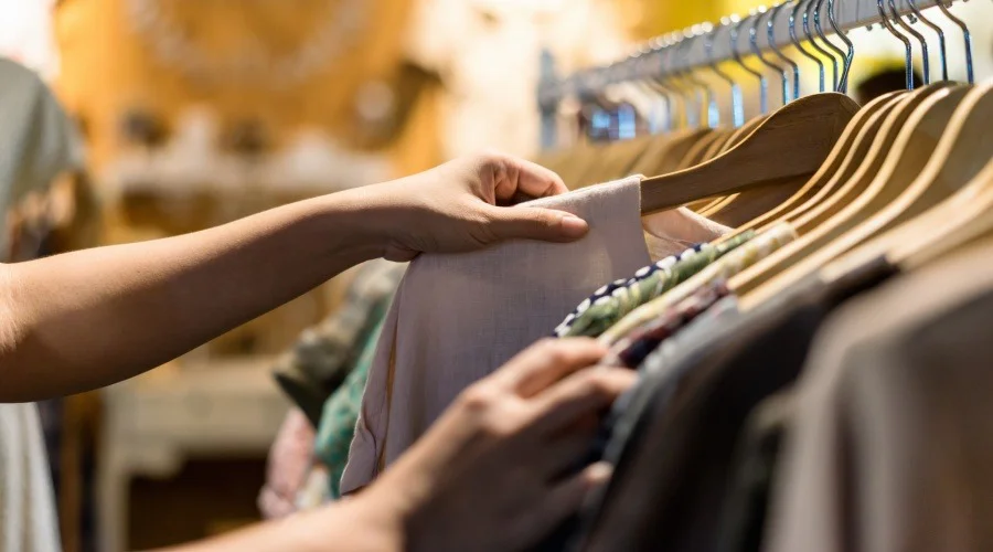 someone picking out an item of clothing in a store