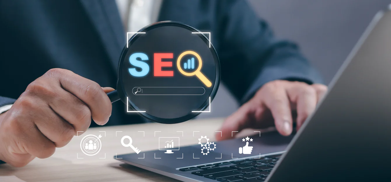 a man using a laptop and holding a magnifying glass with the word SEO on it