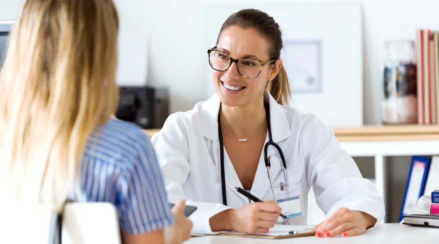 a smiling doctor speaking to a patient
