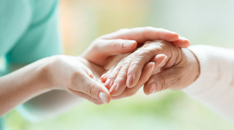 holding the hand of an elderly patient